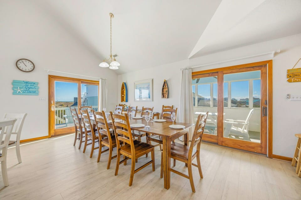 Gather around this spacious dining table where your group can share meals while enjoying stunning views through the large windows.