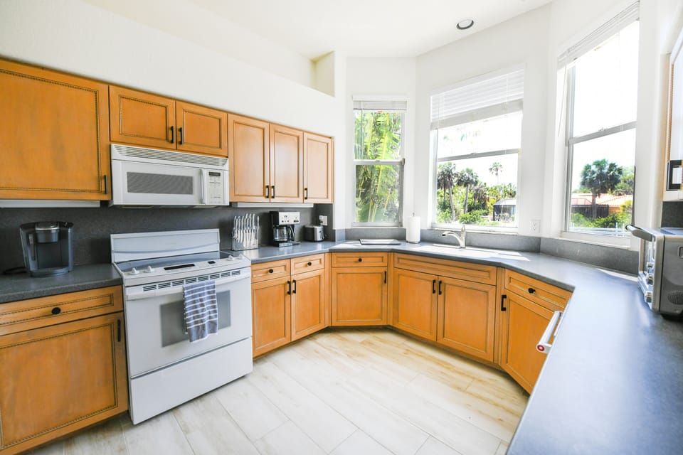 Bright windowed kitchen overlooks your beautiful backyard and the canal.