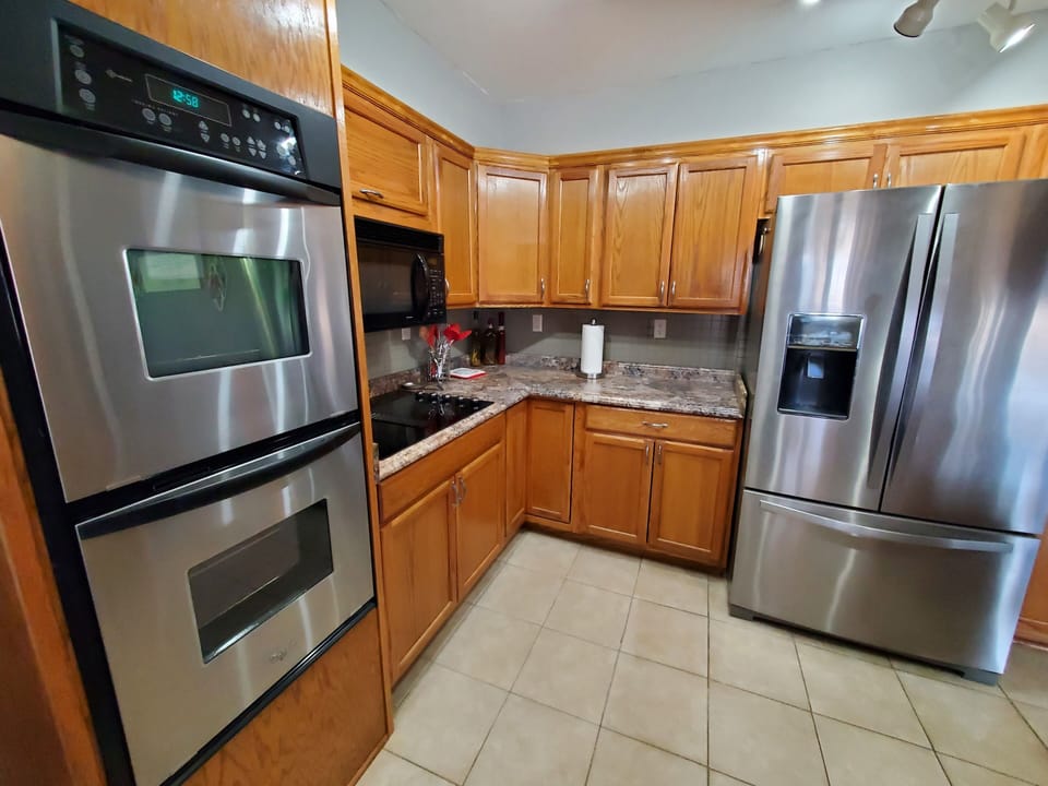 Kitchen with lots of cabinets with pull outs and a Fridge water/ice in door