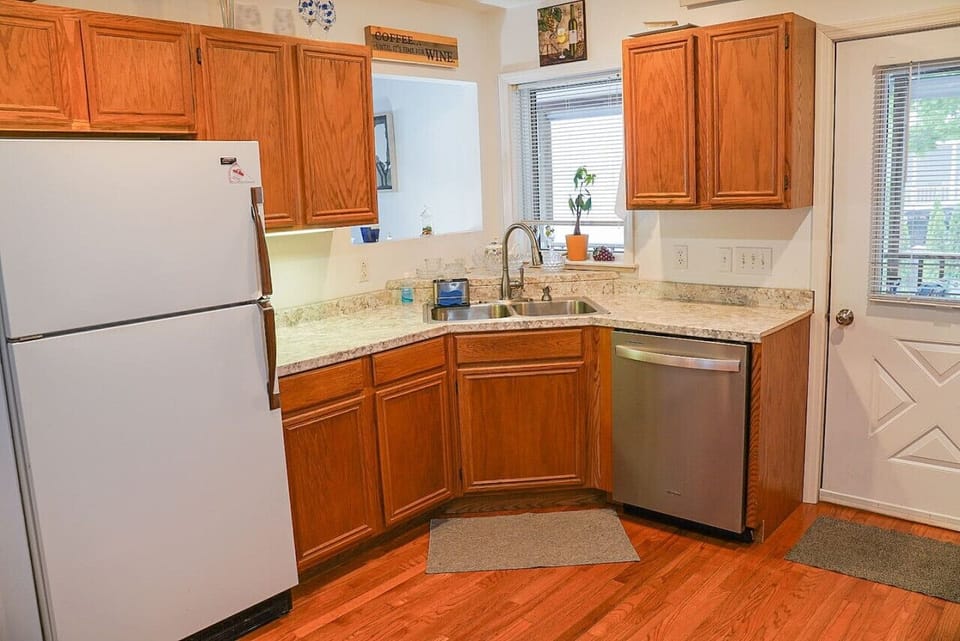 Kitchen highlights include seating for 4-6, a Keurig coffee machine with provided pods, a dishwasher, complimentary pure spring water dispenser, a microwave, a toaster oven, and plenty of various baking dishes, utensils, and spices.