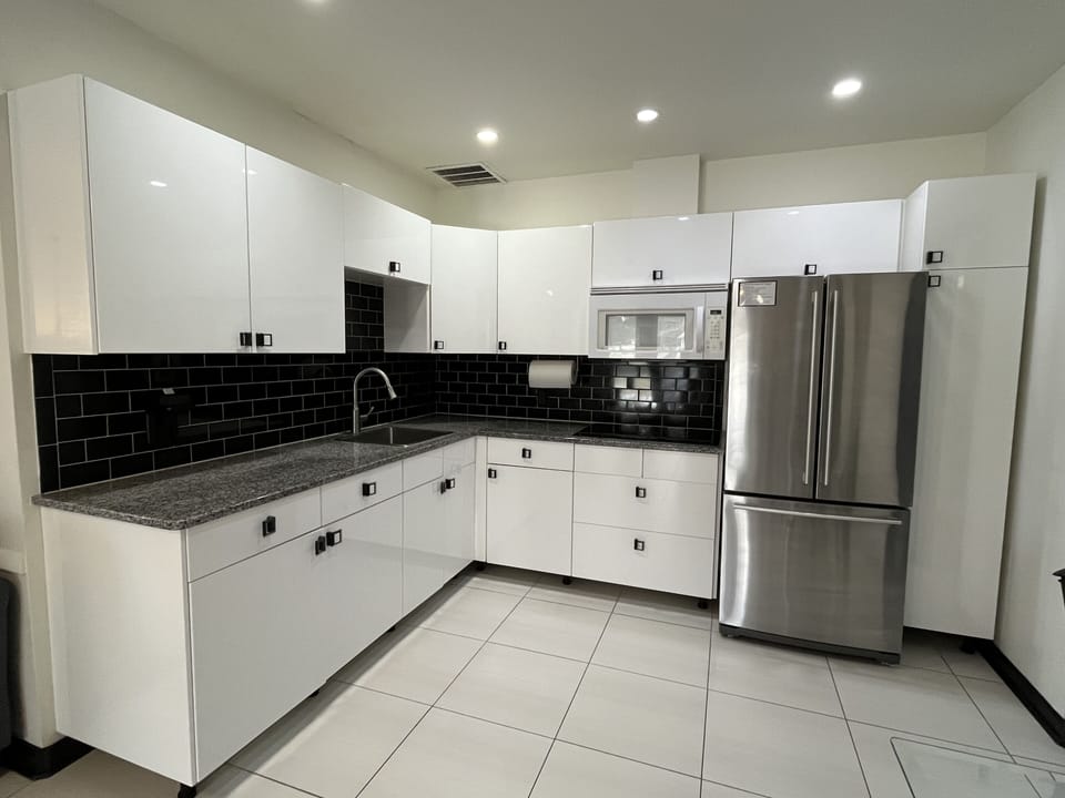 Sleek modern kitchen with stainless appliances near beach & downtown