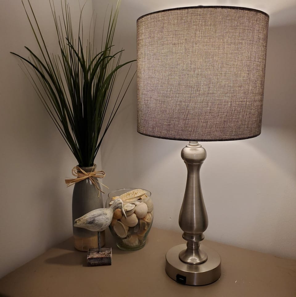 Bedside lamp with USB charging port for added guest convenience.