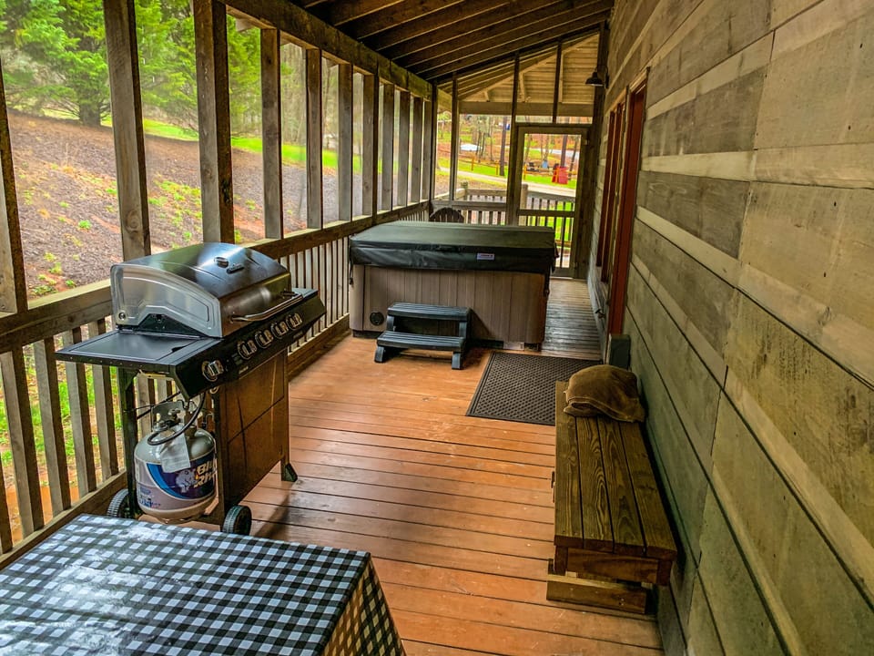 Screened in hot tub and grilling area