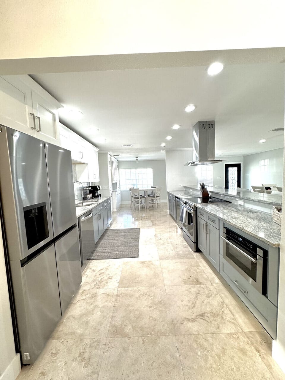Amazing Spacious Kitchen stocked with all of your cooking needs and Large Bar for additional seating