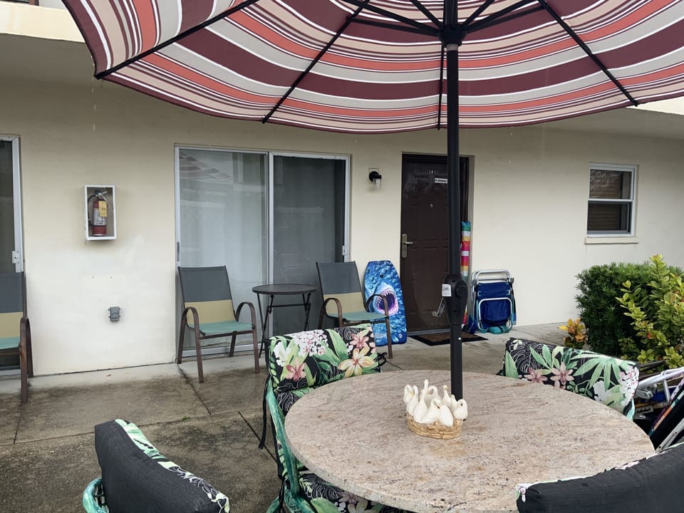 Outside sitting/dining area table, chairs, umbrella