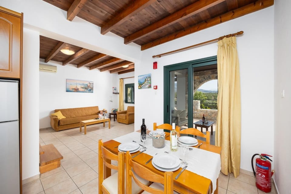 Upper unit: open-plan living room with sofa, dining area, kitchen, A/C, WiFi internet, and satellite TV