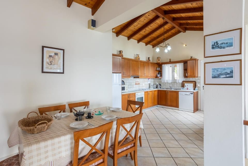 Open-plan living room with sofas, dining area, kitchen, ornamental fireplace, WiFi internet, satellite TV, and sea views