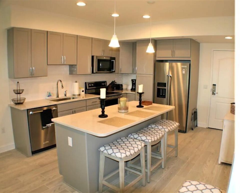 Fully stocked kitchen with seating at dining table and kitchen island