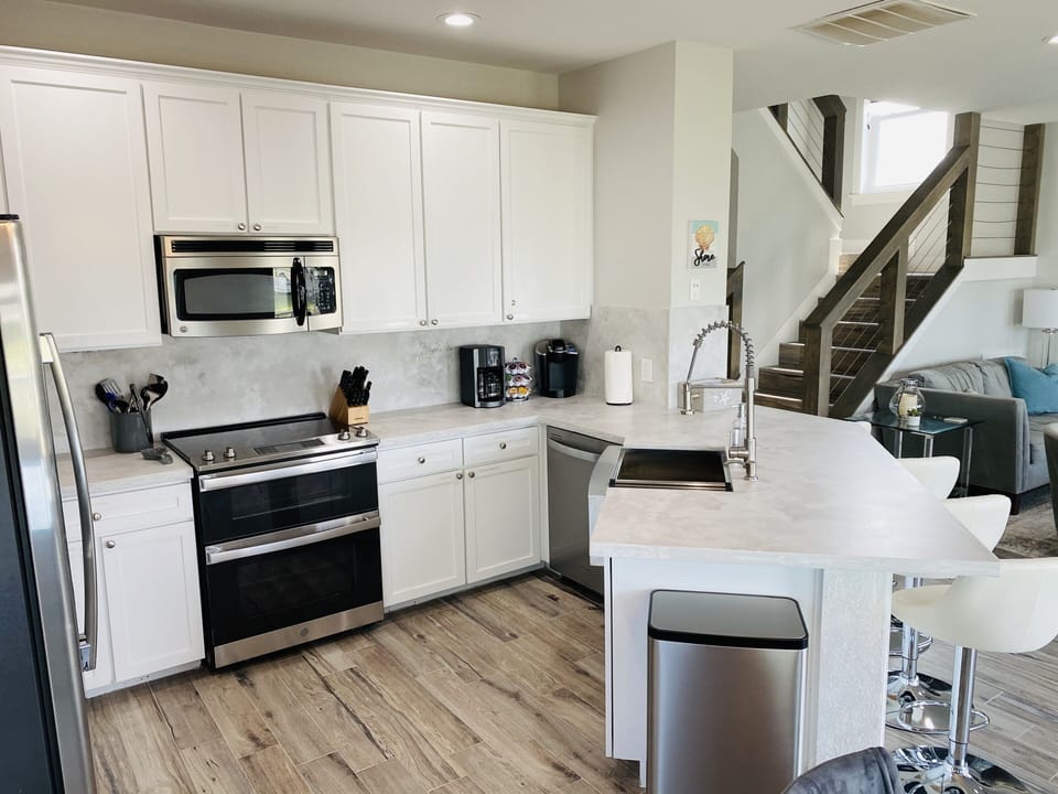 Double oven, dishwasher, large sink & faucet; fridge w/ filtered H2O & ice.