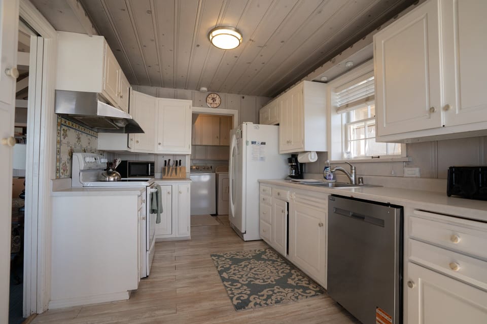 This kitchen offers a classic design and is fully stocked with all the essentials for cooking and dining. Featuring a brand new dishwasher