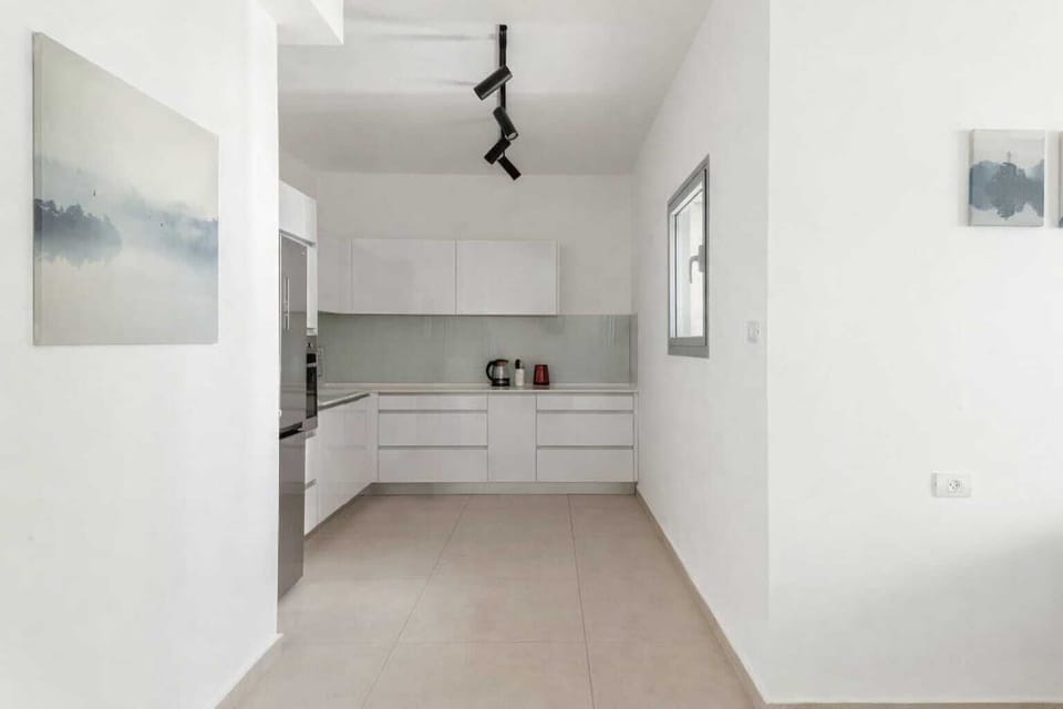 Minimalist interior corner enhancing openness and flow while maintaining calm, uncluttered atmosphere throughout the apartment space.
