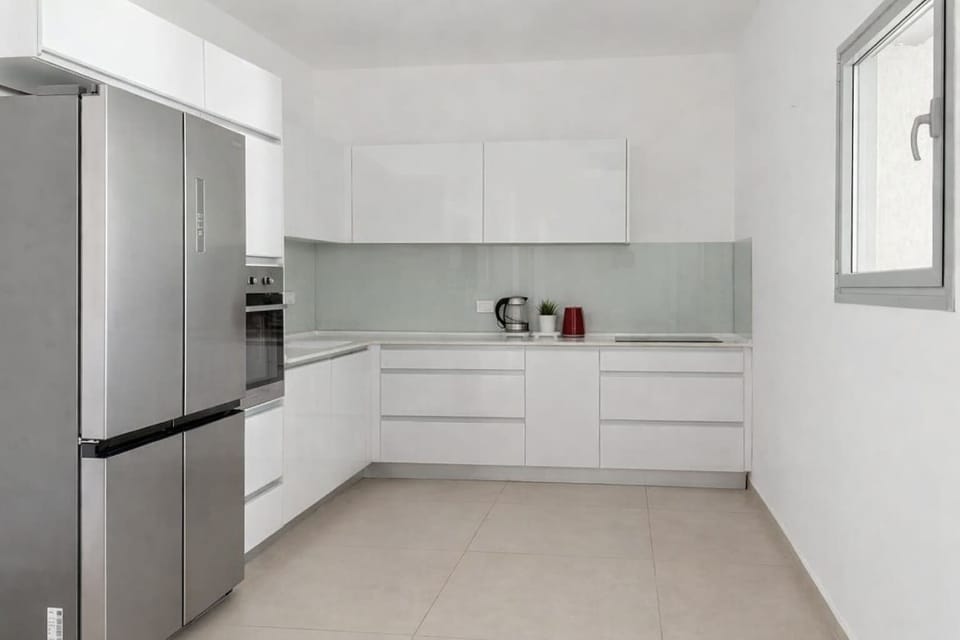 Modern kitchen layout allowing effortless meal preparation during comfortable extended seaside stays.