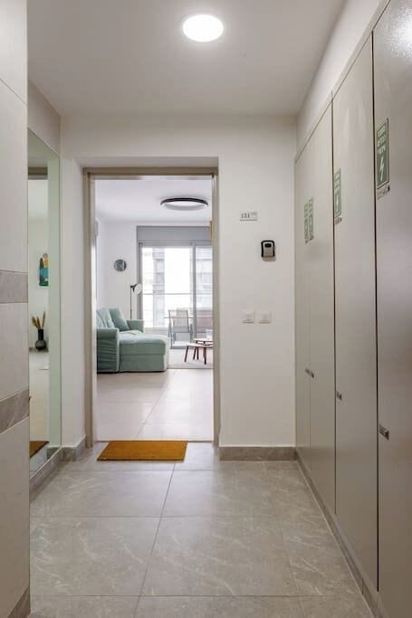 Thoughtfully arranged hallway guiding naturally toward bright living spaces filled with natural daylight.