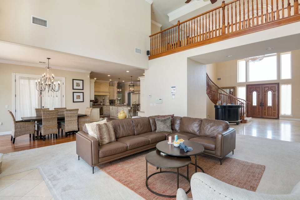 Main living room features leather couches.