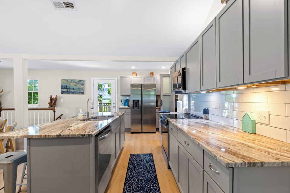 Bright modern kitchen with granite counters and spacious island
