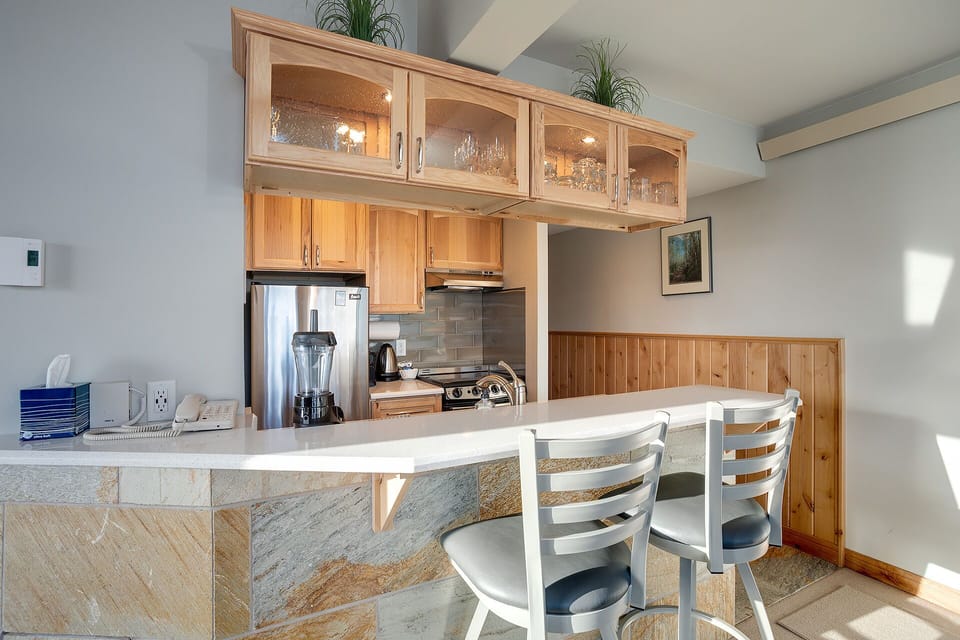 Your fully equipped kitchen awaits with granite counters, stainless appliances, and a breakfast bar perfect for morning coffee or casual meals together.