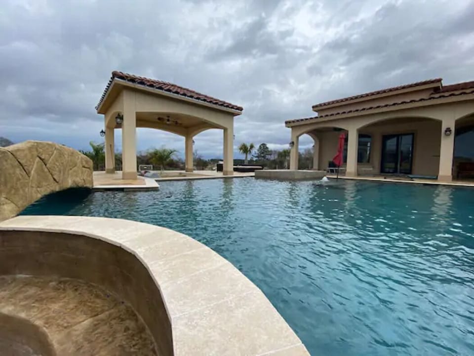 Resort Style pool with outdoor BBQ area and hot tub. 