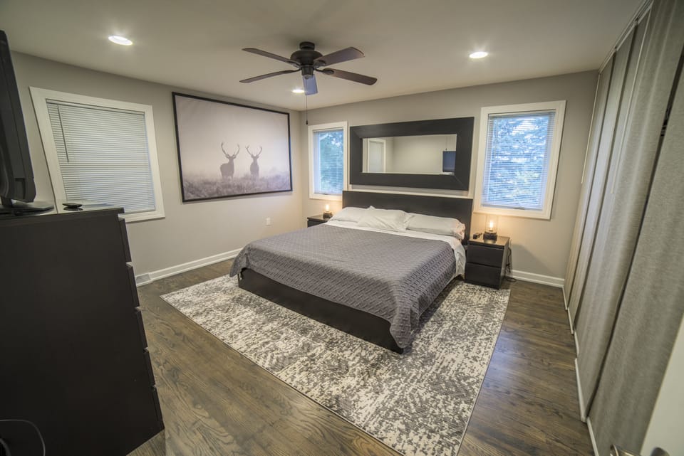 Large main bedroom with king size bed and modern furnishings.