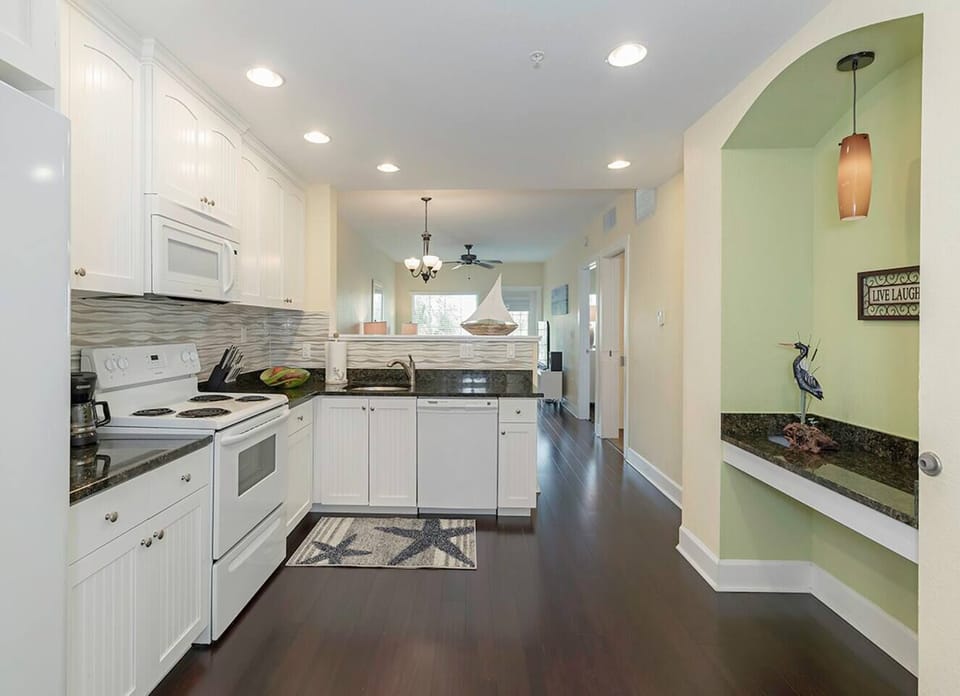 The kitchen - microwave, dishwasher, full size fridge, pots/pans, dishes and a Mr. Coffee