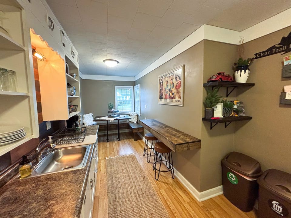 Modern and efficient—everything you need to create a delicious meal. The kitchen features a stainless steel refrigerator, stove, coffee maker, kitchenette oven, kettle, and blender