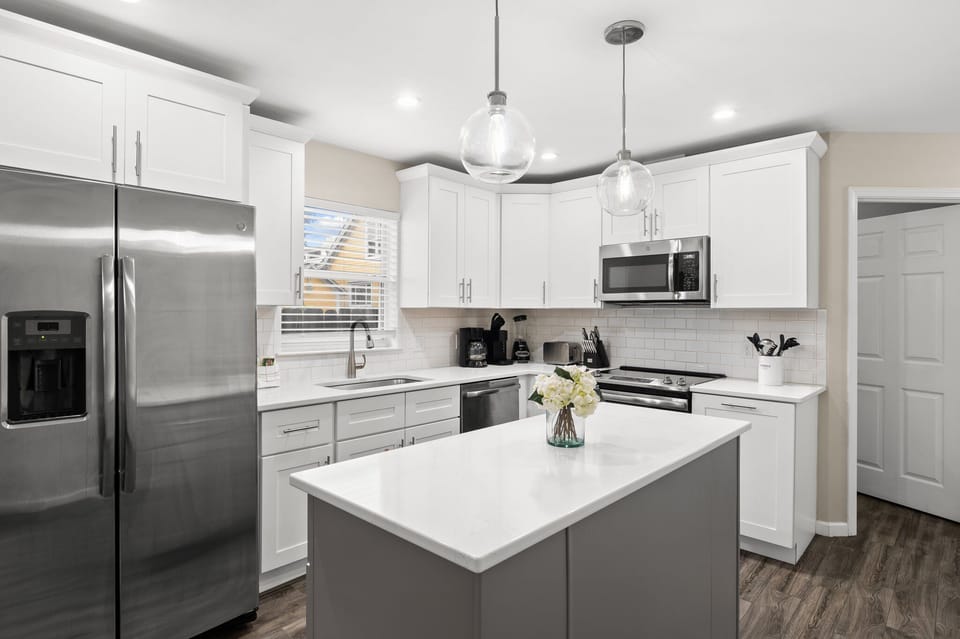 Beautifully updated modern kitchen with quartz counters and stainless appliances