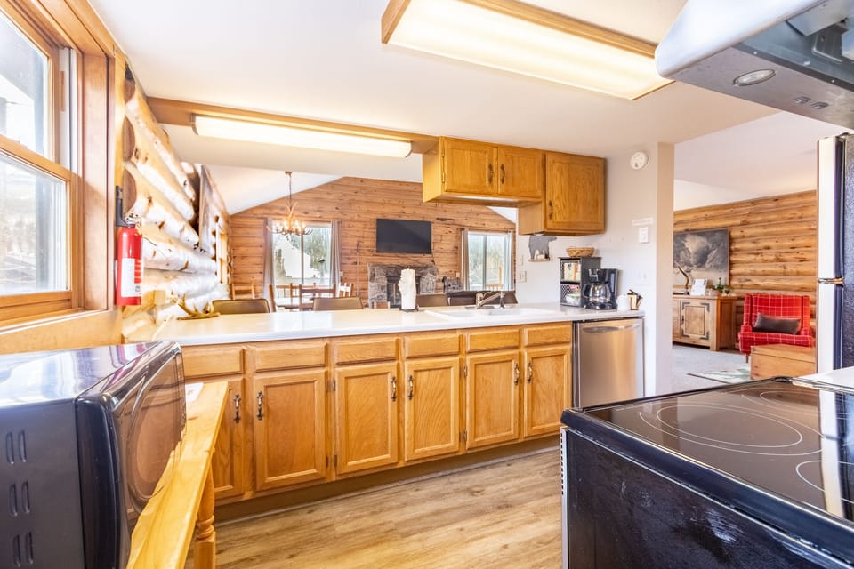 Your spacious kitchen features warm wood cabinets, modern appliances, and skylights that fill the space with natural light for memorable meal prep.