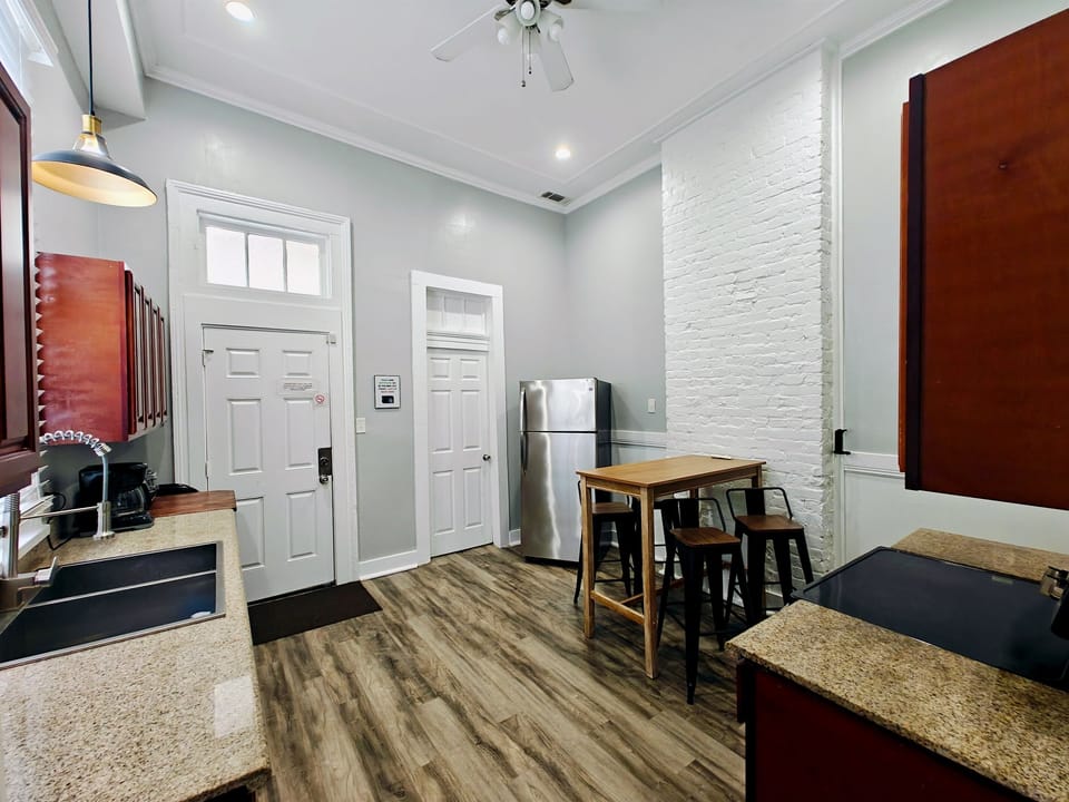 Kitchen looking at door to rear courtyard and bathroom. 