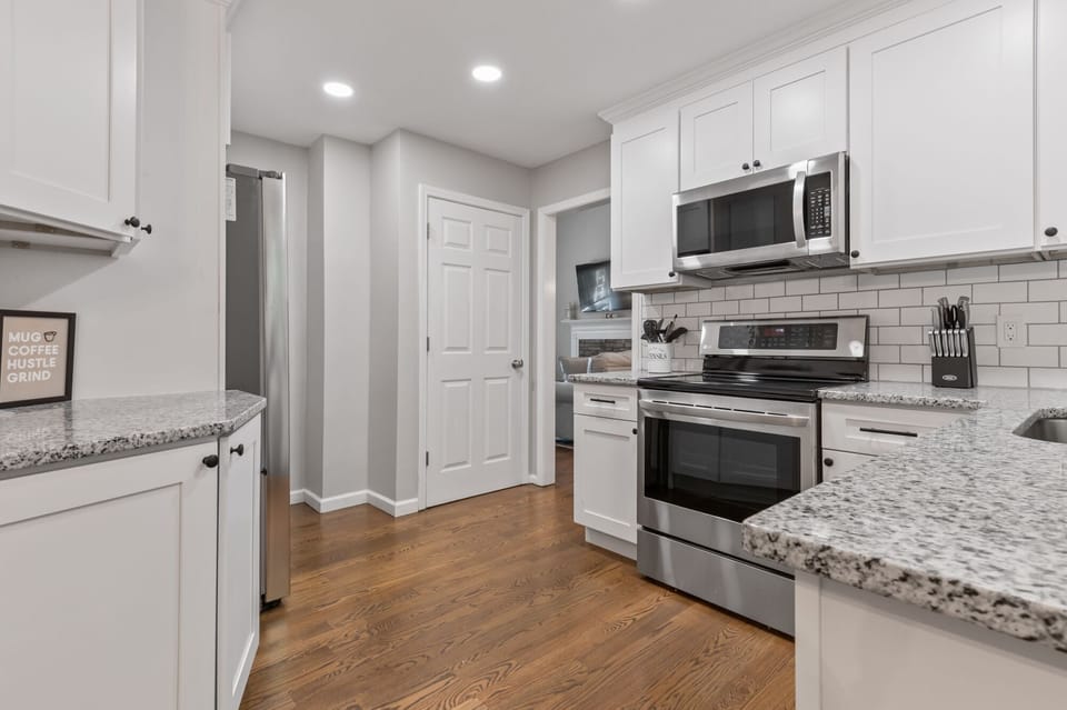 Kitchen adjoins to living/dining room with doorway to finished basement and two car garage. Glass top electric stove/oven, microwave, dishwasher and large double door refrigerator. Coffee bar in breakfast area.