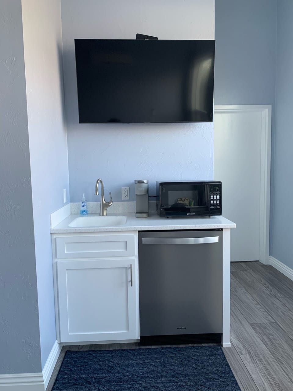 Mini bar area with sink, coffee pot, microwave, mini fridge & big screen T.V. 