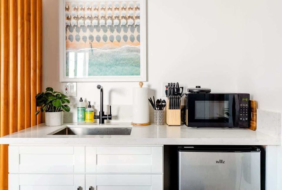 Brew your morning coffee or prep a quick snack in our sleek kitchenette, with the essentials to make your stay feel just like home.

