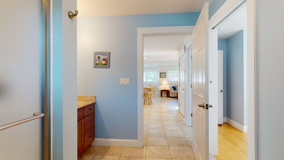 Two entrances to bathroom, through bedroom and through kitchen