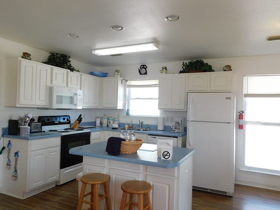 Spacious Kitchen with Over the Stove Microwave. Refrigerator includes Ice Maker.