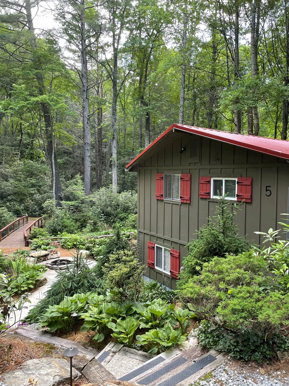 Over 2 acres of outdoor space with creek, waterfall, fire pit, covered deck.