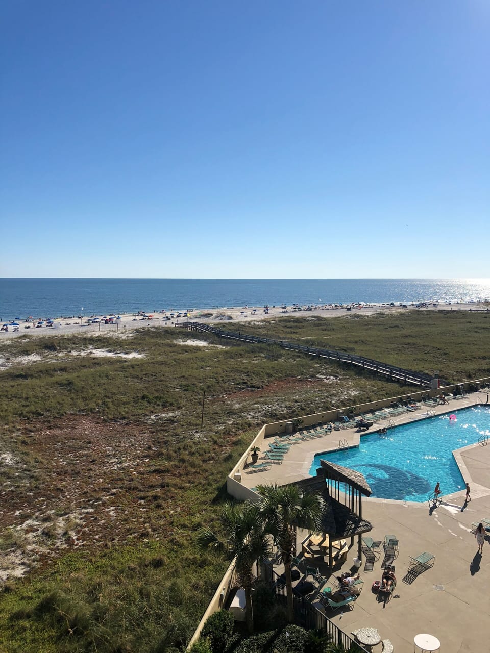 Balcony view of the beach and pool