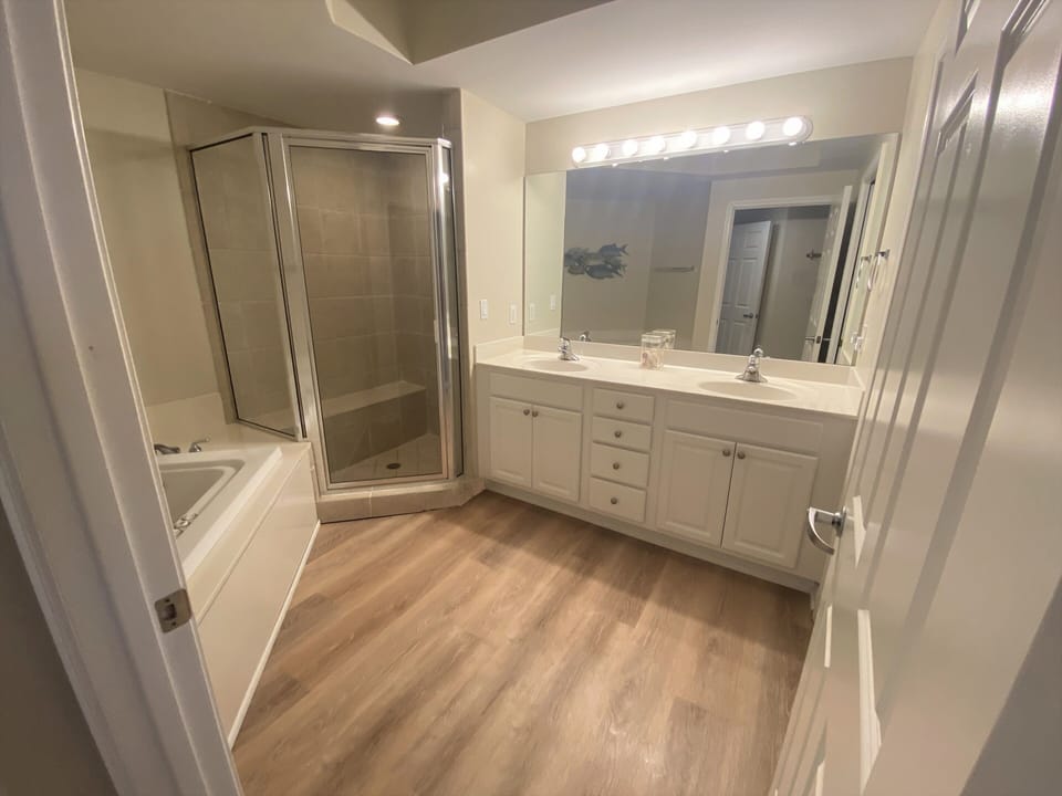 Master bathroom with walk in shower and soaking tub.