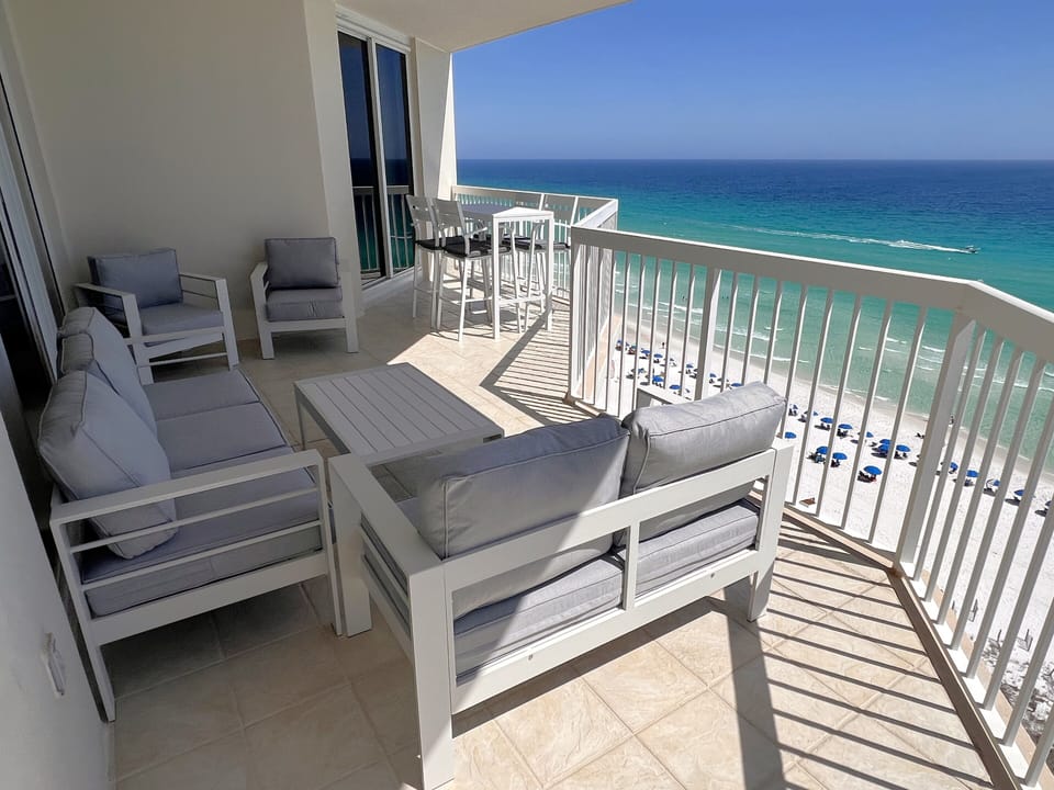 Large ocean front balcony with sofa &  loveseat!  Balcony seating for all ten!