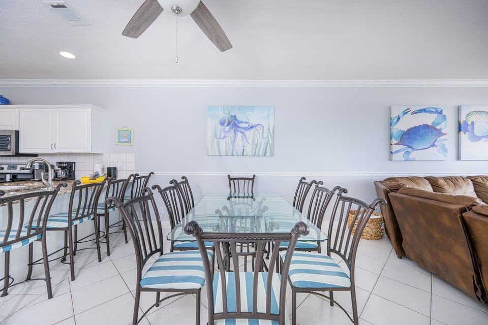 Gather around the glass dining table to enjoy lively mealtime conversations with family and friends in the dining area