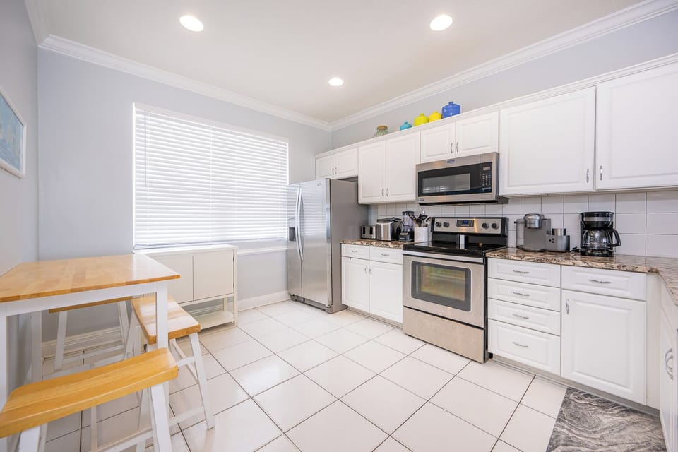 White cabinets and stainless appliances brighten your kitchen as you prepare fresh meals with ease