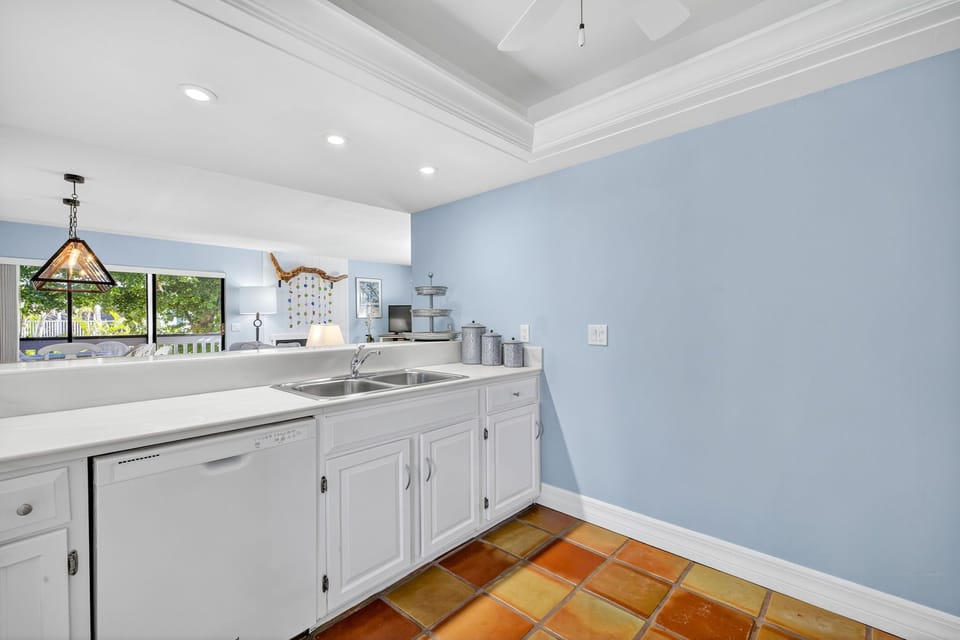 Bright and open kitchen with ample counter space, white cabinetry, and modern appliances—ideal for preparing meals and gathering together.