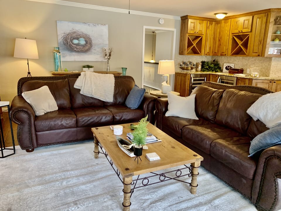 Open Living area next to dining area with two wine fridges. 