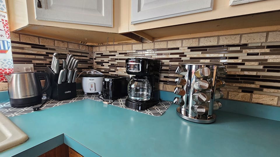Kitchen fully stocked  with coffee maker, rice cooker, toaster,hot water pot