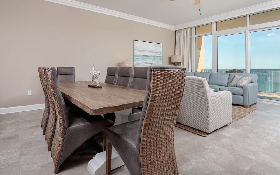 Gather around the stylish dining table, where laughter and conversation flow amid coastal breezes and light
