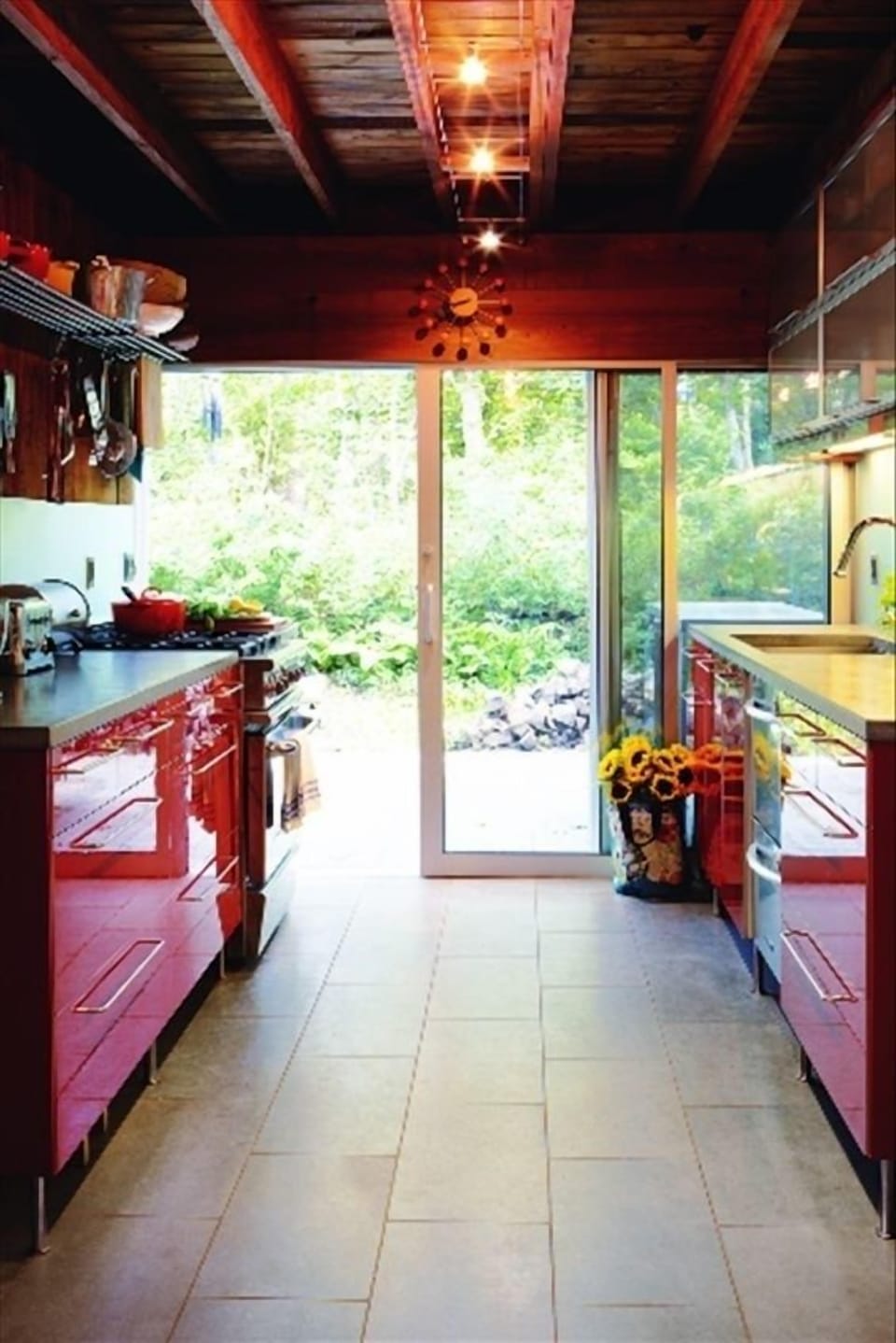 Red kitchen--leads outdoors to patio with gas grill and charcoal grill