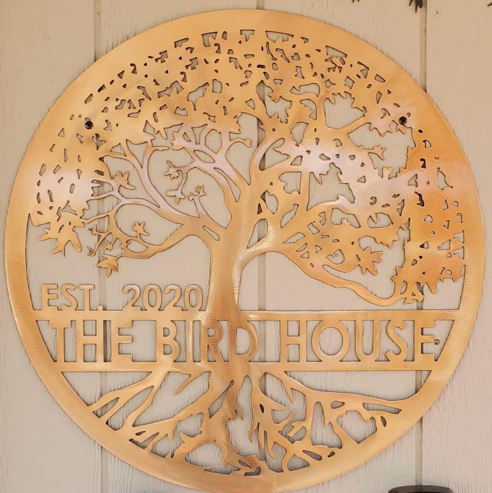 The Bird House front door sign
