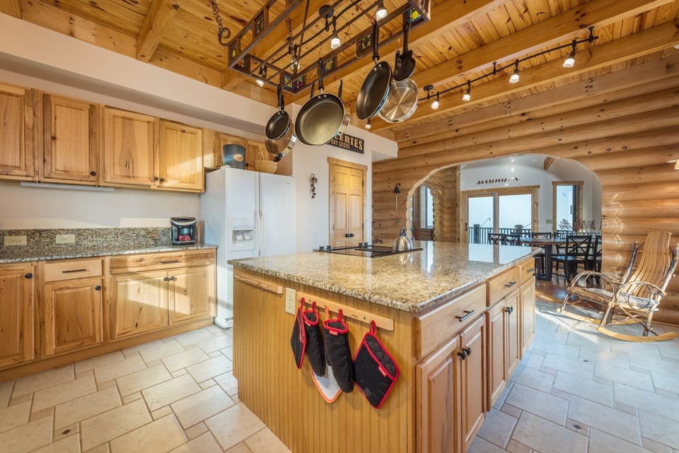Kitchen with a dishwasher, island seating, and 2 types of coffeemakers (Drip-style & Keurig).
