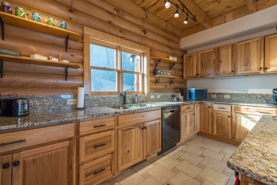 Kitchen with a dishwasher, island seating, and 2 types of coffeemakers (Drip-style & Keurig).