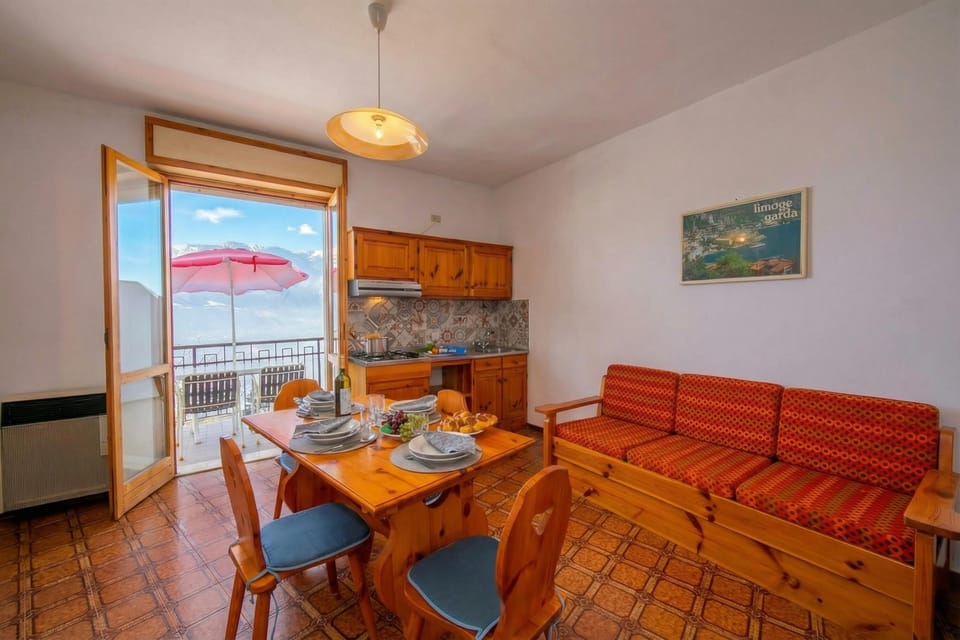 The living room with dining table and access to the balcony