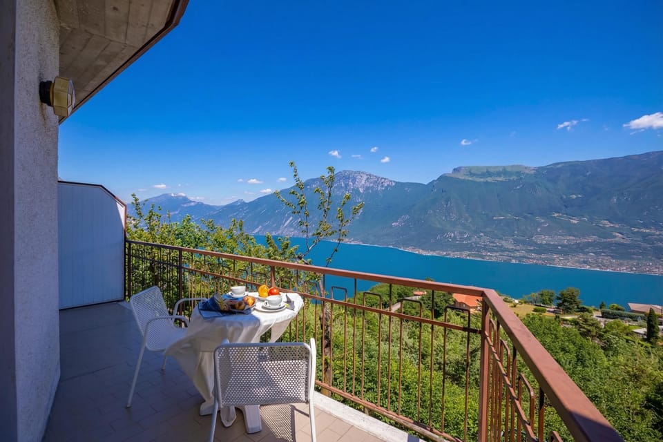 The balcony overlooks the lake and the mountains