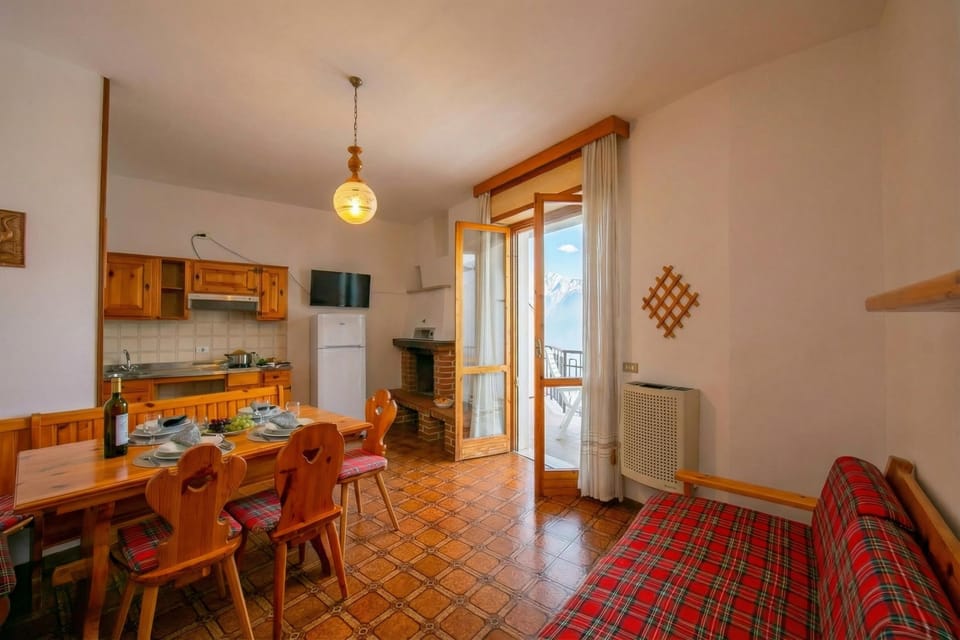 The living room with dining table, armchairs and kitchen counter