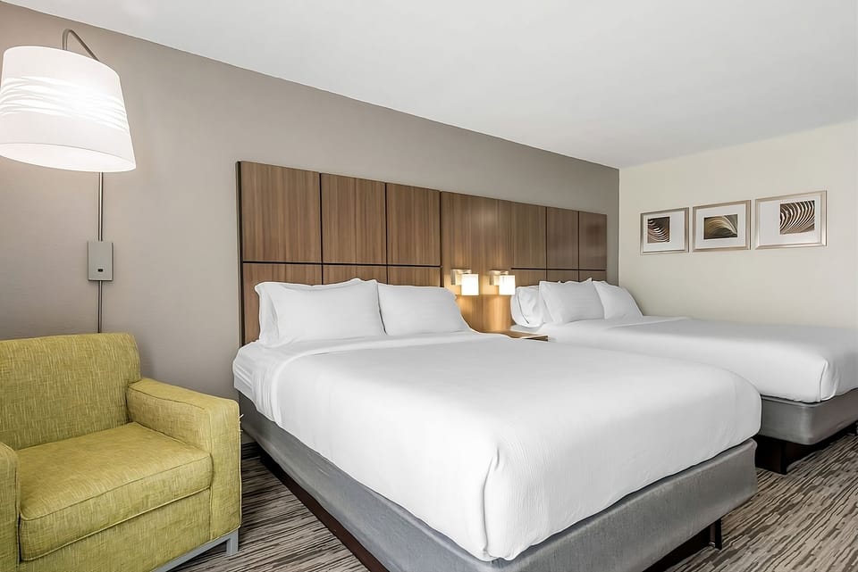 Unwind on crisp linens in a spacious double-queen retreat.